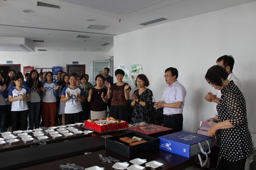 Company leader cutting the celebration cake